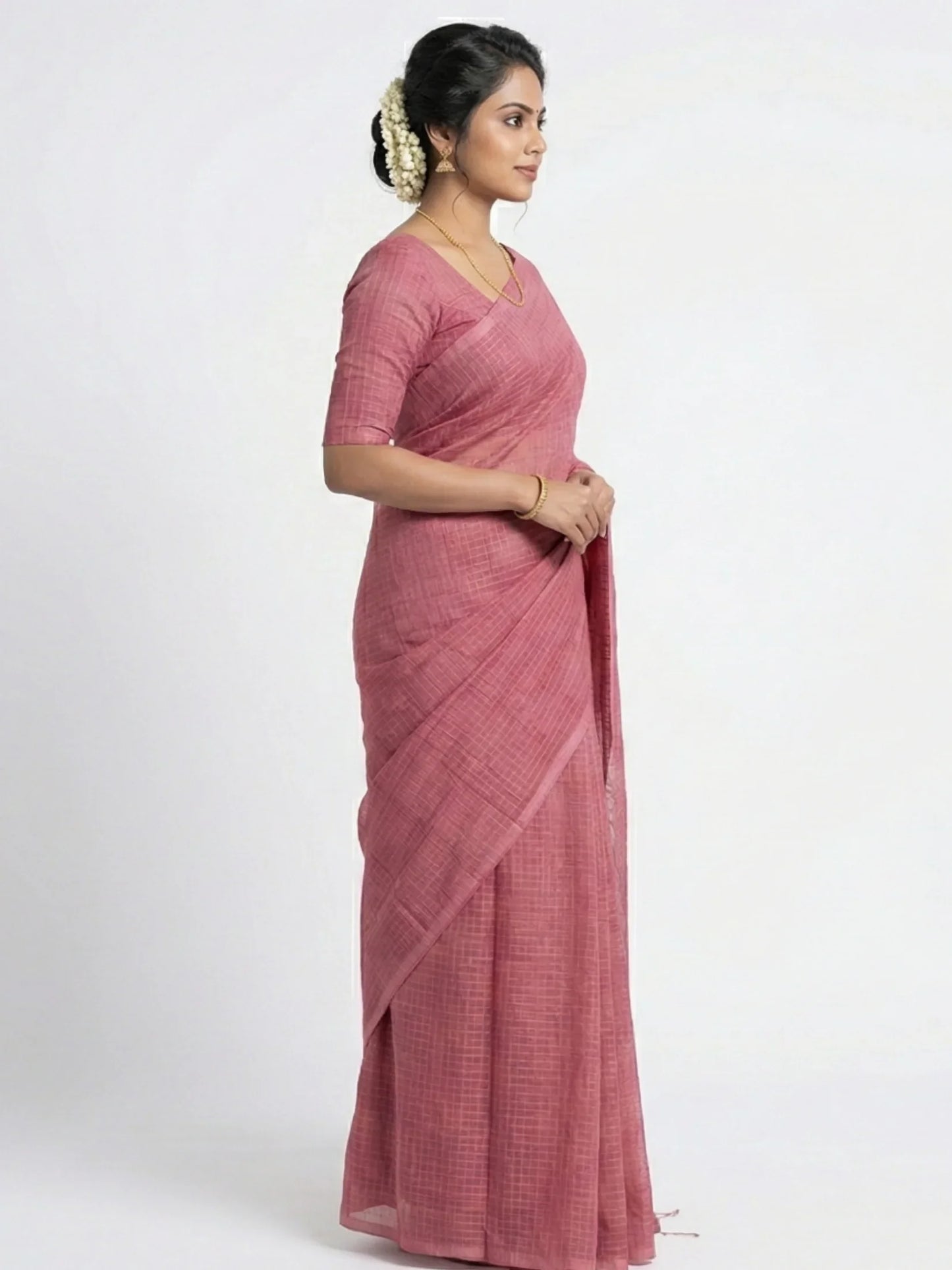 Woman wearing a pink saree on a white background