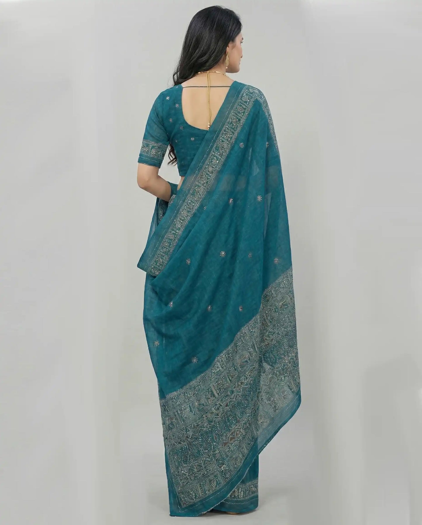 Back view of the peacock blue Jodhpuri cotton saree, highlighting the blouse fit and the intricate print on the pallu.
