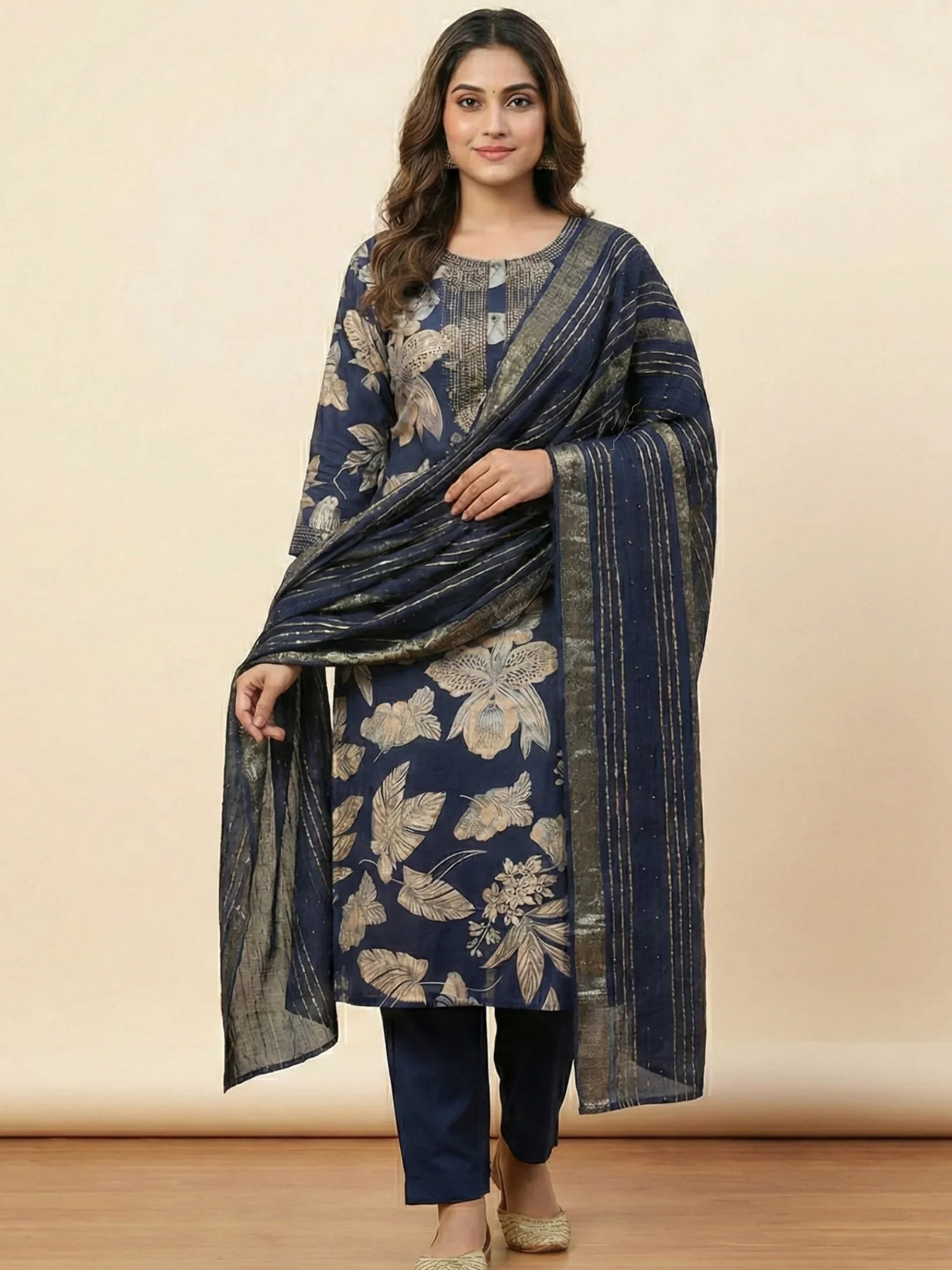 Indian model elegantly draped in a navy blue ethnic suit featuring a gold-striped zari dupatta and botanical leaf prints