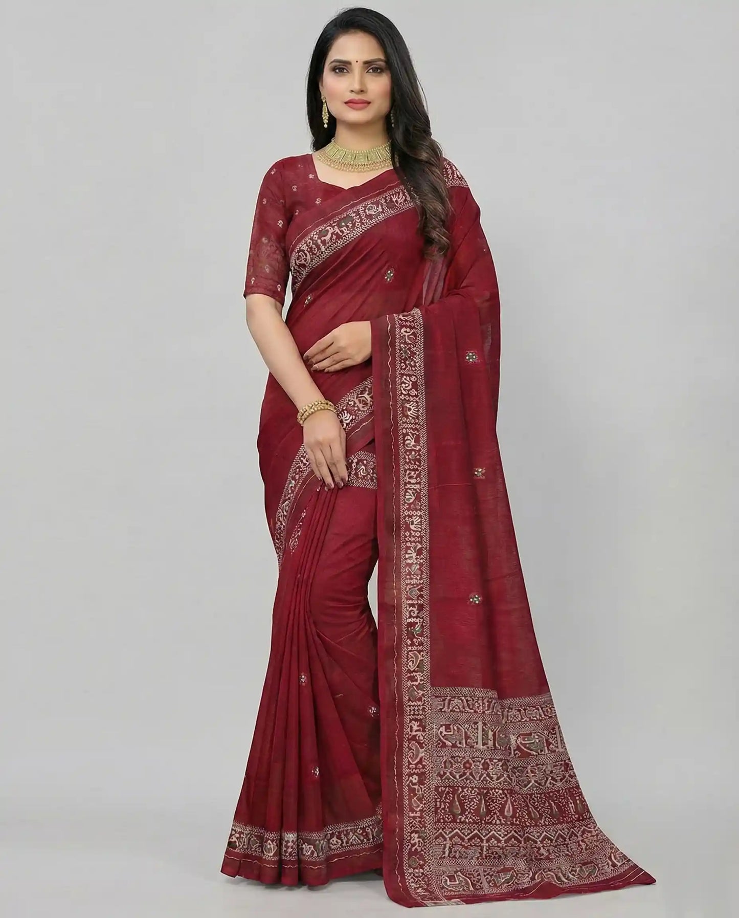 A professional model wearing a deep maroon traditional saree featuring white elephant and bird motifs on the pallu and an ornate border, designed by Sherly's Attire.