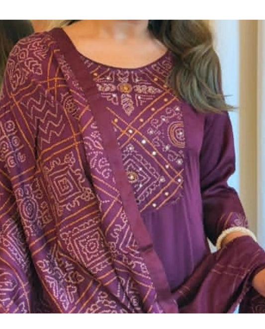Close-up of intricate gold and beige embroidery on the chest of a purple kurti