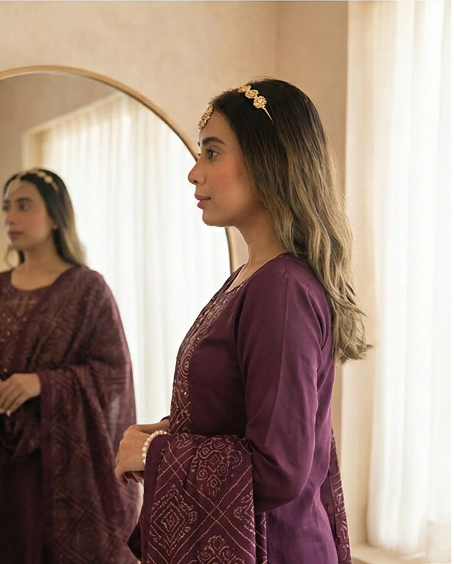 Side view of a premium plum kurti showing the sleeve fit and dupatta drape.