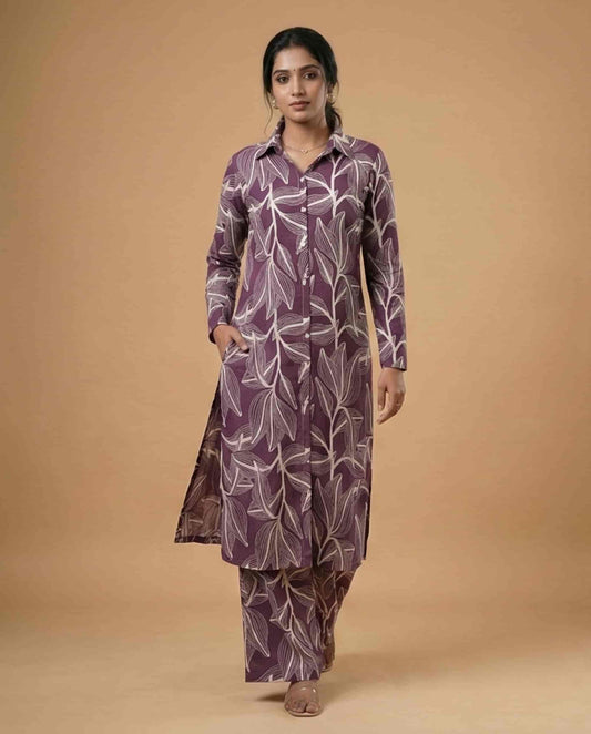 Woman wearing a purple leaf-patterned outfit on a beige background

