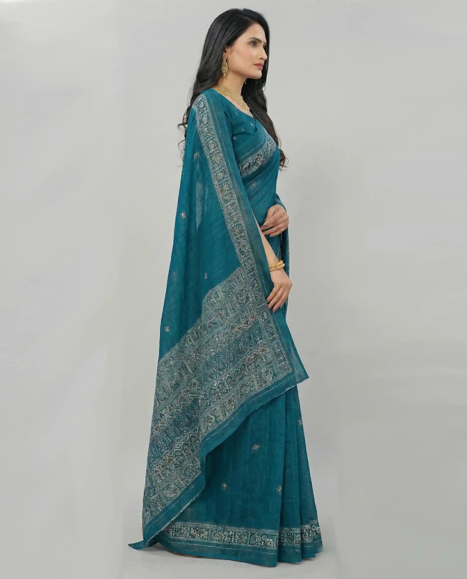 Side profile of a woman wearing a teal Jodhpuri cotton saree, showing the breathable fabric texture and elegant drape.